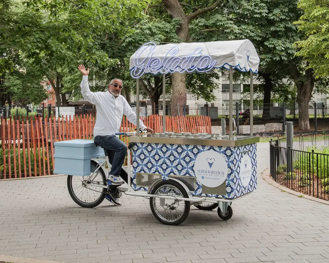 The MiniMizzica gelato trike, canopy lettered “Gelato”, ridden through a Toronto park